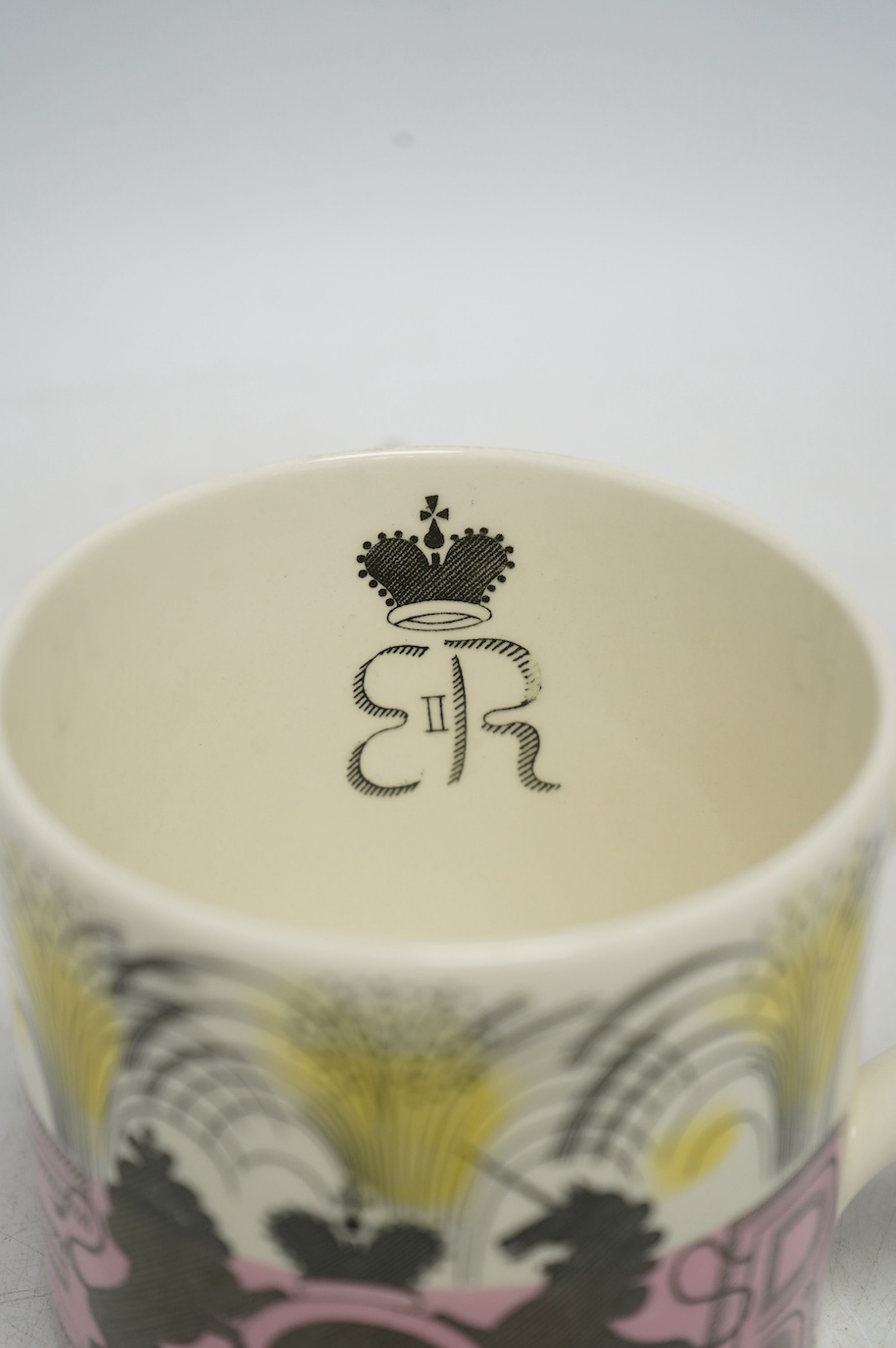 Eric Ravilious for Wedgwood, a 1953 Coronation mug, 10.5cm high, together with a Laura Knight coronation mug. Condition - fair to good